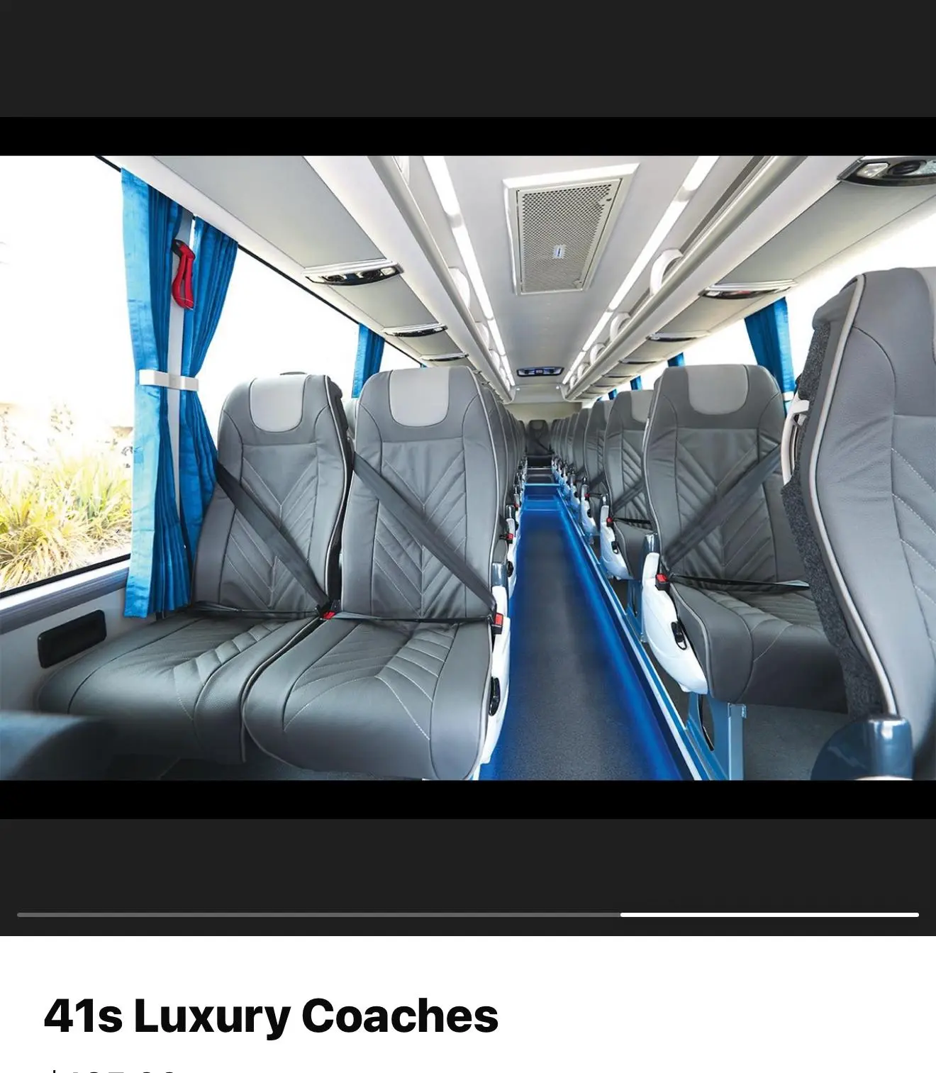 The aisle and seating inside a luxury coach