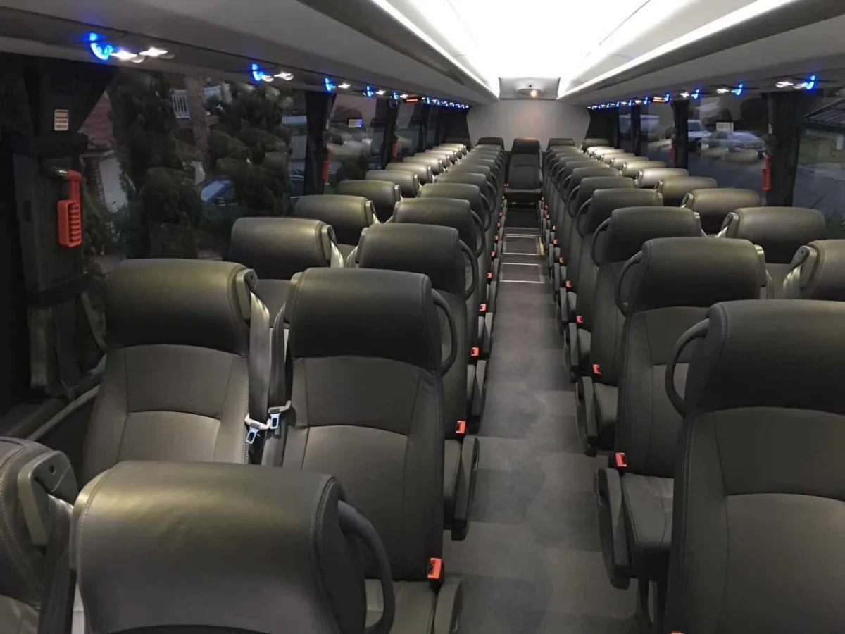 The aisle and seating inside a mid-size bus